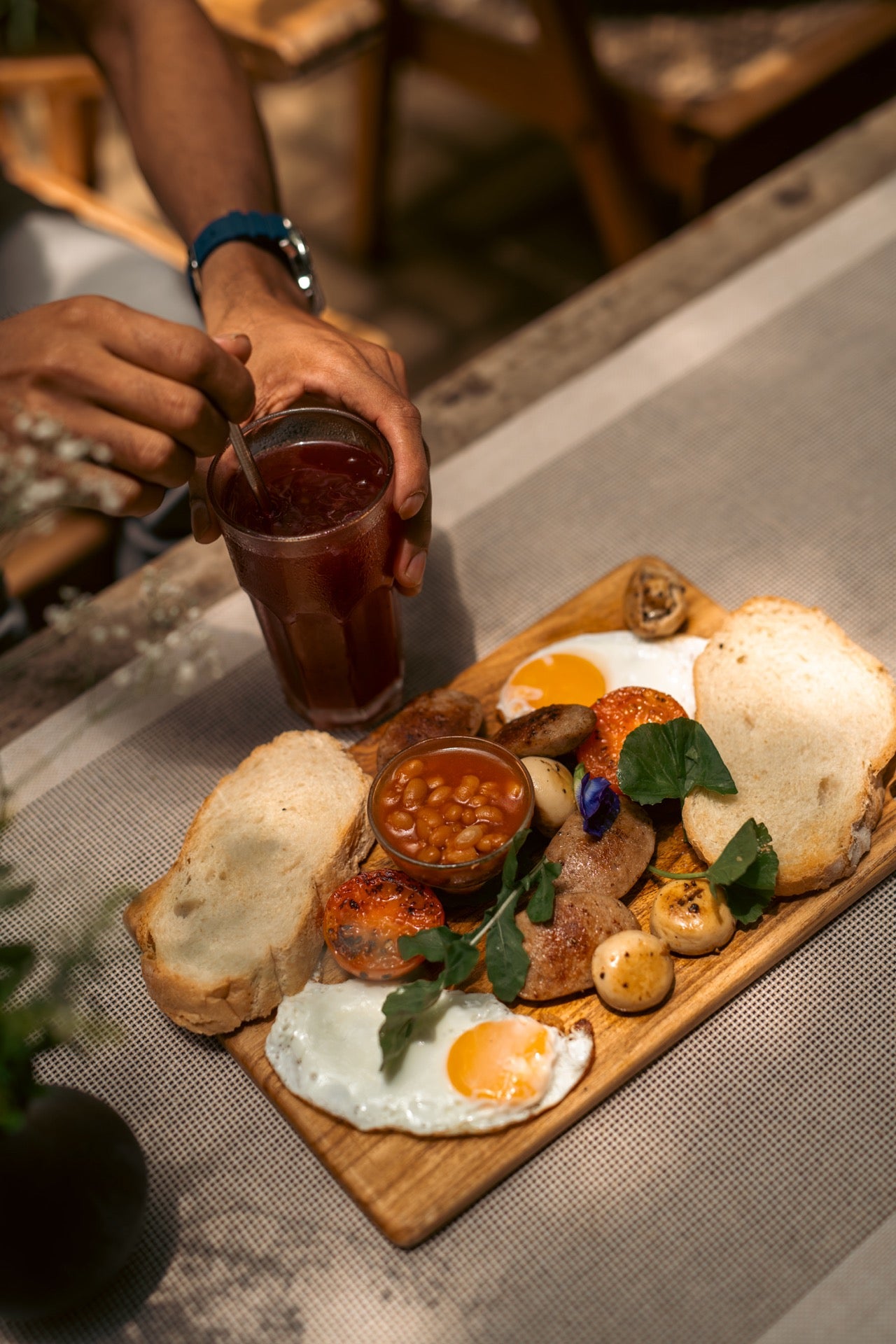 A brunch plate served on a wooden platter at Wild & the Sage café, restaurant and bookshop in Galle