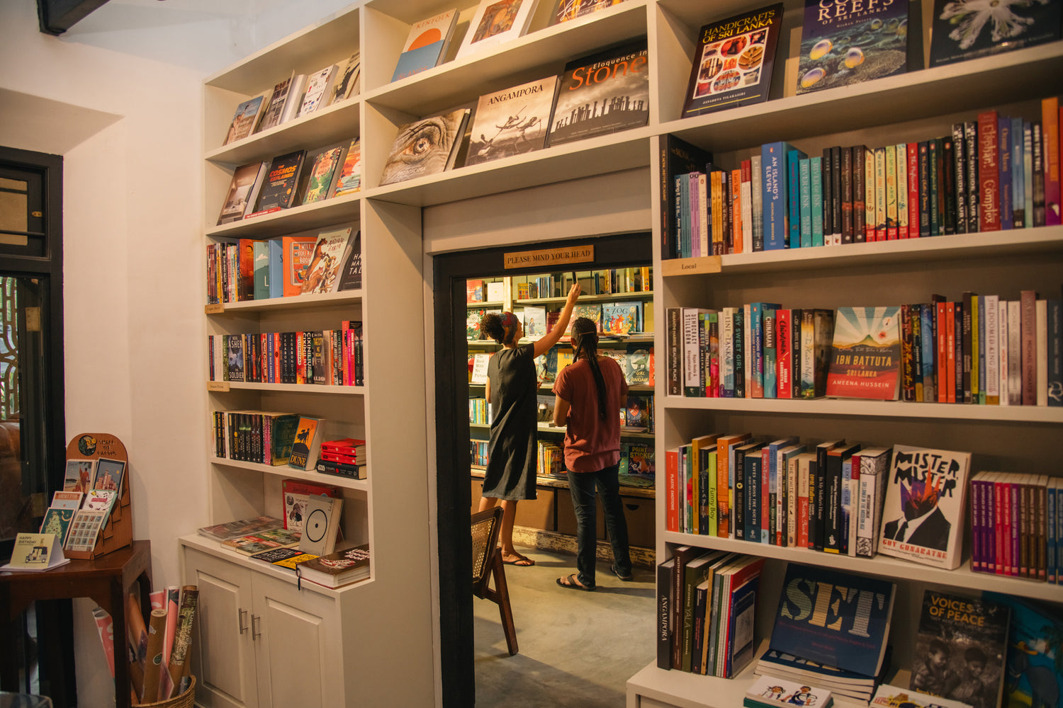 Interior of Wild & the Sage bookshop in Galle, showing a wide range of books stacked high on shelves