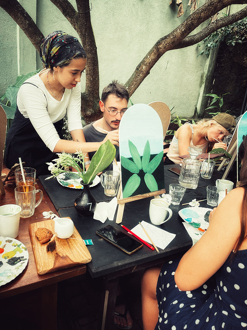 Guests take part in a creative painting workshop at Wild & the Sage bookshop in Galle