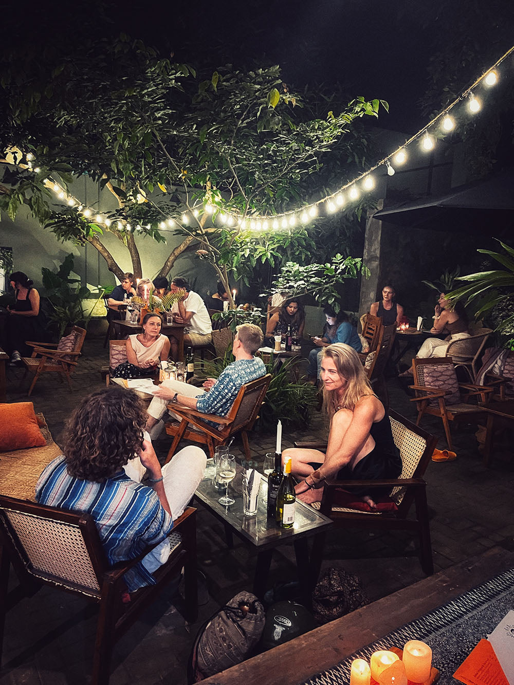 Guests dine in the garden courtyard at Wild & the Sage independent bookshop in Galle