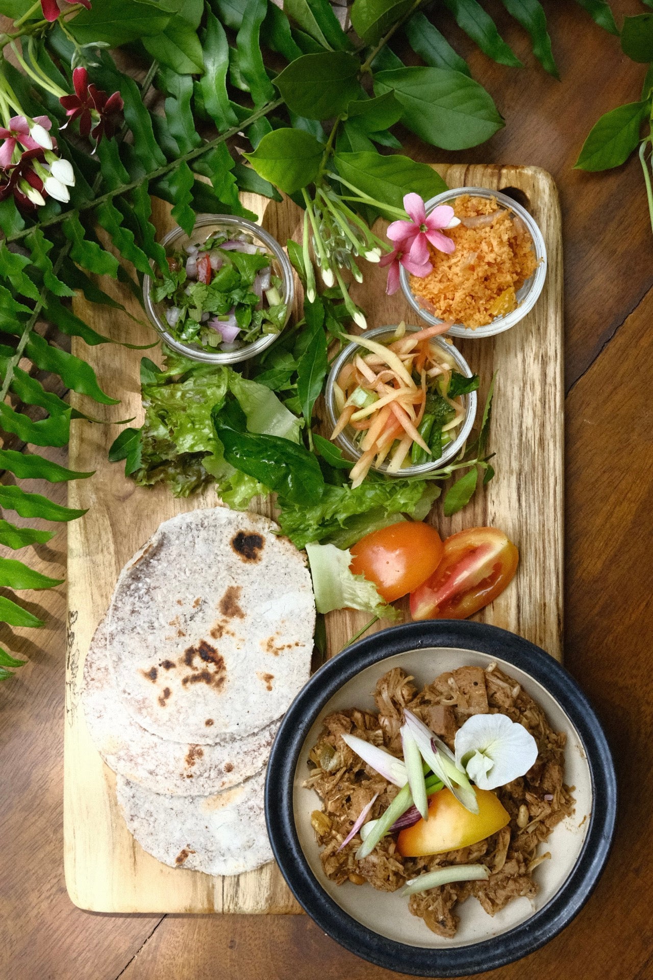 A board of sri lankan inspired pulled jacfruit served at wild and the sage cafe, galle, sri lanka