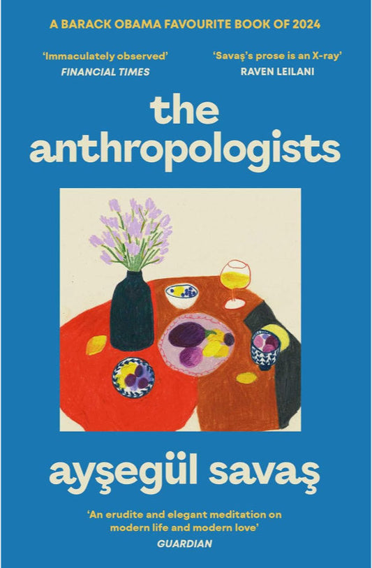 Book cover of 'The Anthropologists' by Aysegul Savas with a blue background and illustration of a table with flowers and a vase.